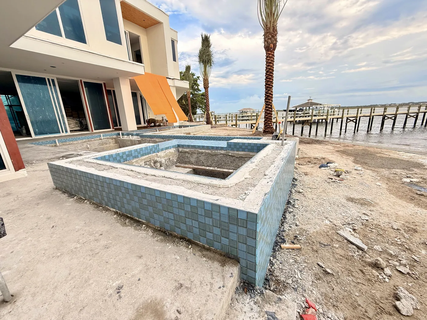 Raised spa walls with tile installed and unfinished surroundings