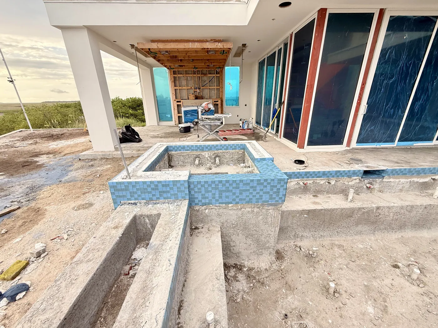 Raised blue tile spa and connecting channel in progress