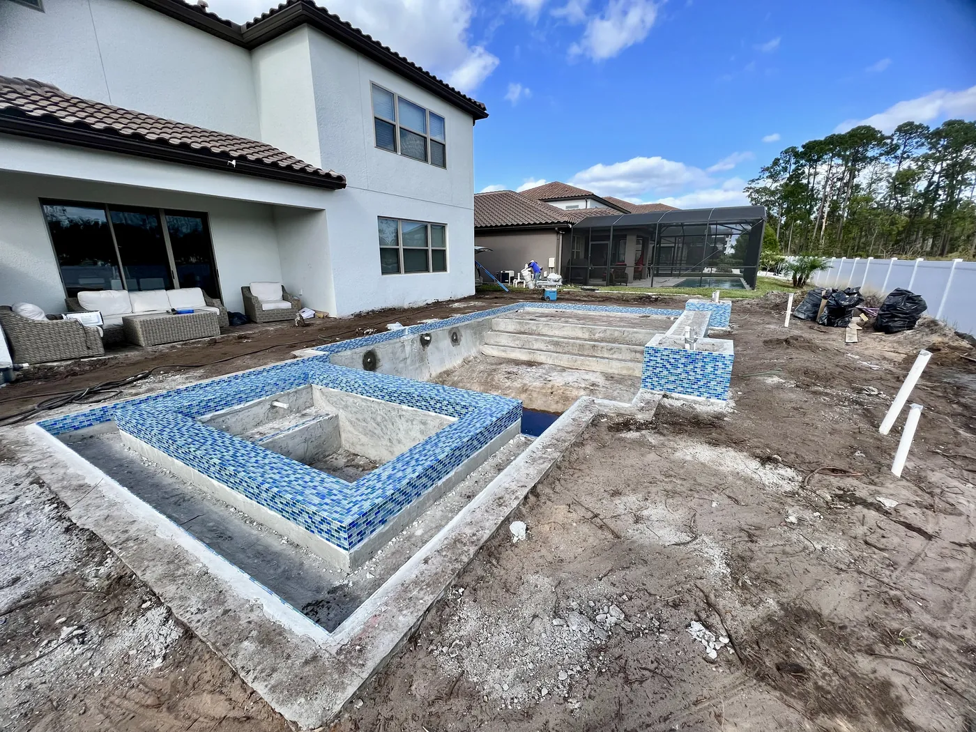 Blue glass tile installed on a raised spa